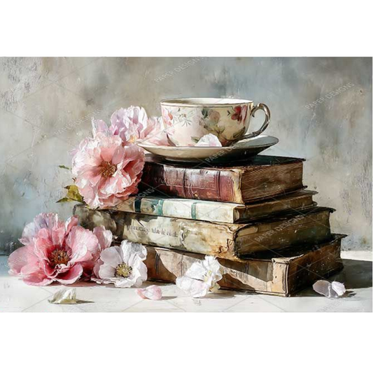 Stack of old books with a floral teacup and pink flowers on a textured surface
