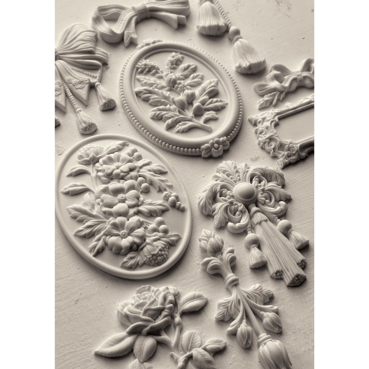 "Victoriana" IOD Silicone Mould by Iron Orchid Designs. Available at Milton's Daughter. Decorative mold with florals, tassels and cameos. Casting example.