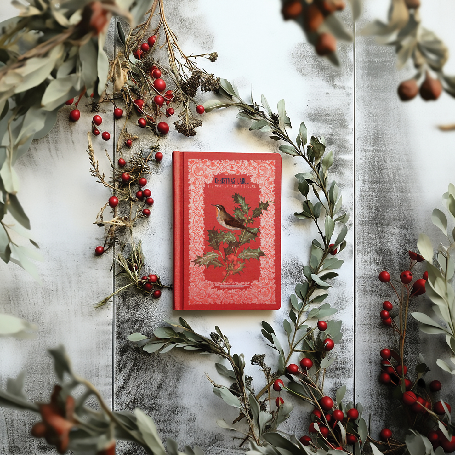 "Winter Botanist" IOD Transfer by Iron Orchid Designs. Example Pic 1. Transfer available at Milton's Daughter. Red book with bird illustration on a decorative background with greenery and berries.