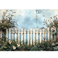White picket fence with flowers and plants against a light blue sky.