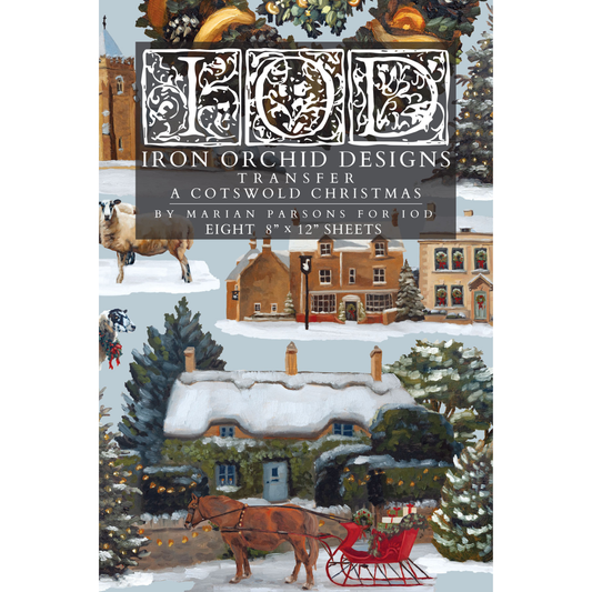 Cover of the 'Iron Orchid Designs Transfer: A Cotswold Christmas' pattern by Marian Parsons, featuring a winter village scene with a snow-covered cottage, horse-drawn sleigh, trees, and historic houses.