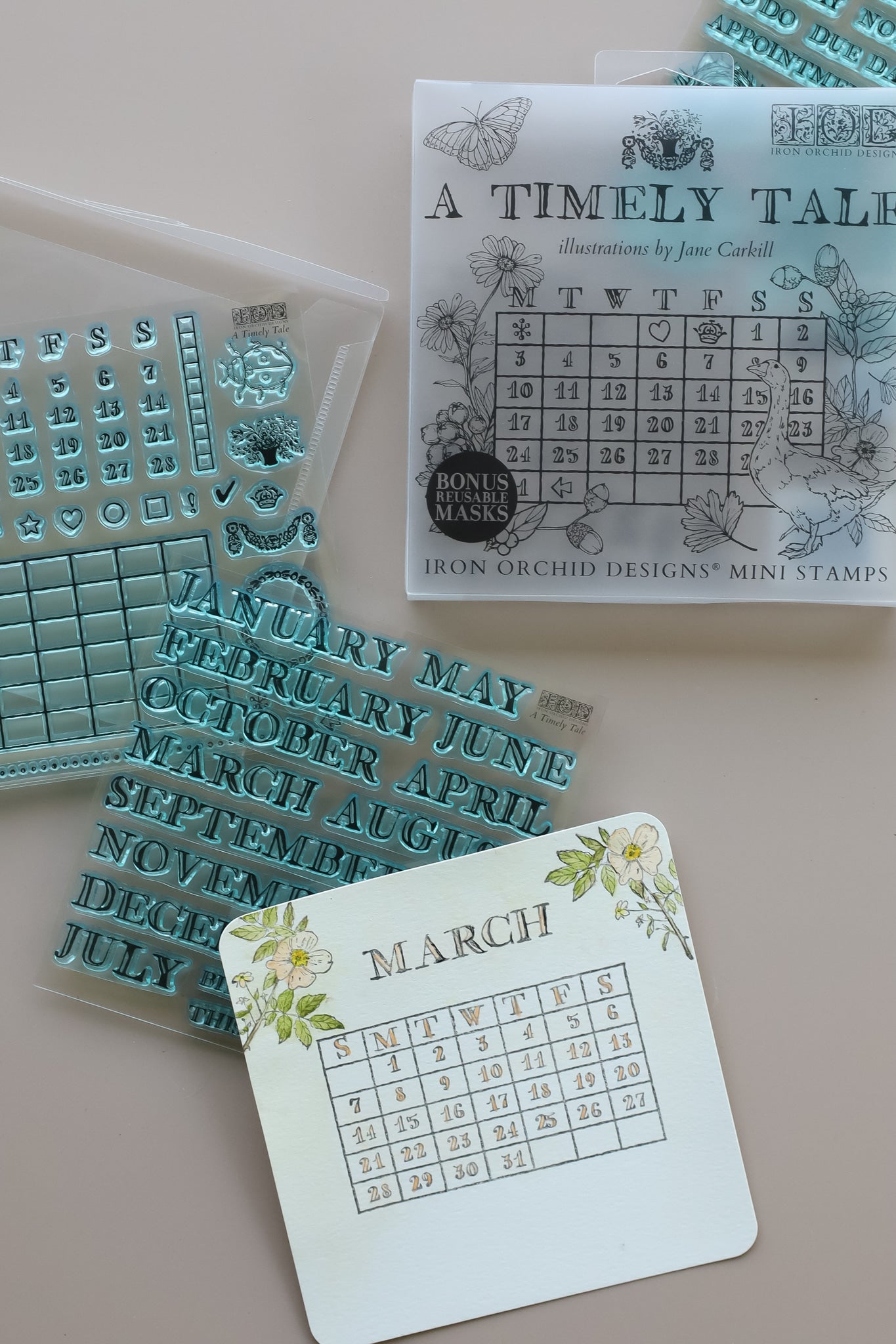 A collage of mini stamp sheets  from Iron Orchid Designs' 'A Timely Tale' collection, featuring various decorative designs in light gray and teal-blue tones on a white background.