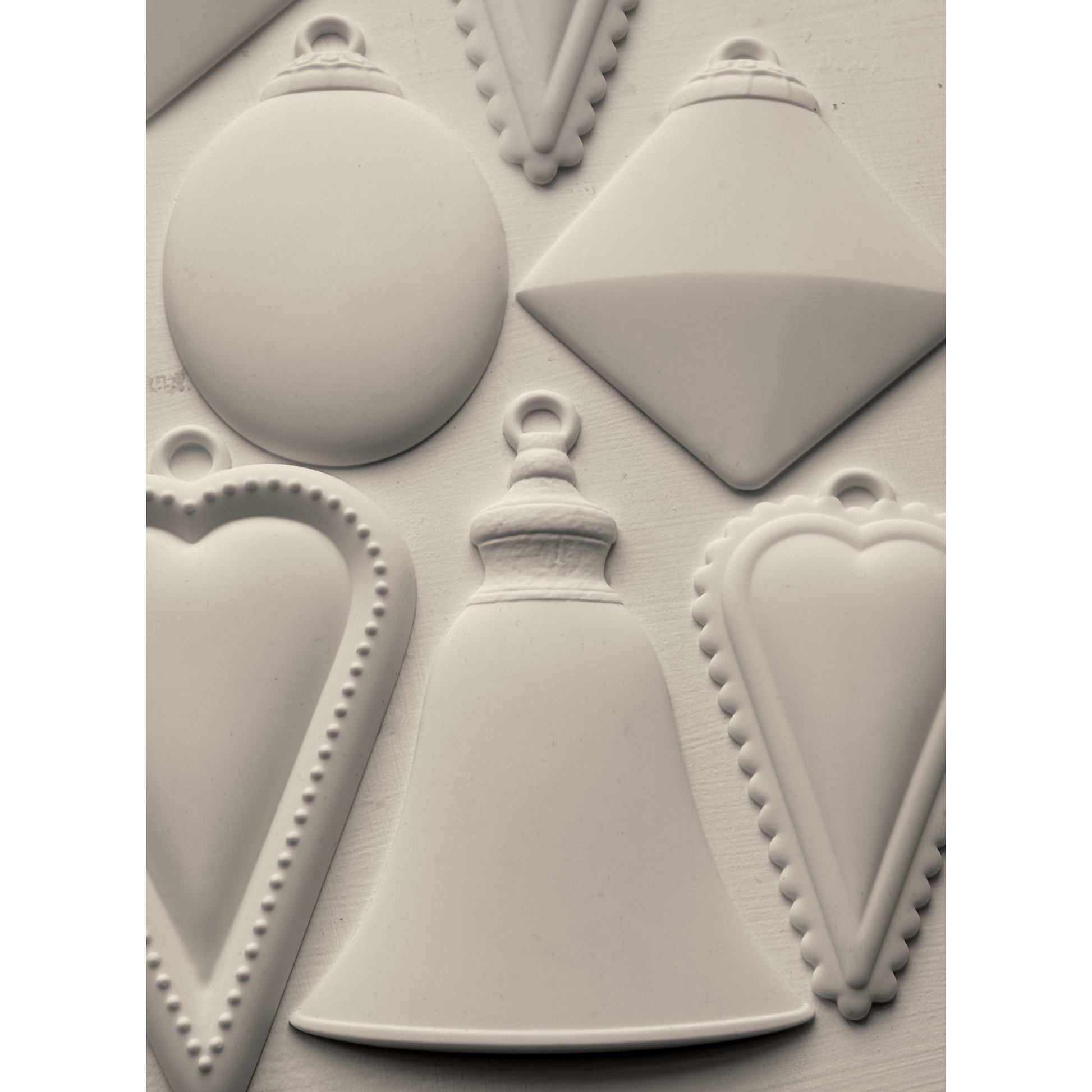 "Bibelots 2" IOD Mould by Iron Orchid Designs. Silicone mold with various geometric ornament shapes. Casting example. Available at Milton's Daughter. 