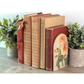 Set of vintage books with decorative cover on a wooden surface with plants.