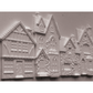 Unpainted castings of houses with detailed medieval and cottage architecture, shown on a plain light background.