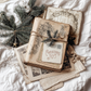 "Christmas Post" IOD Stamp by Iron Orchid Designs. Available at Milton's Daughter. Example pic. Stack of vintage books with Christmas decorations on a white surface