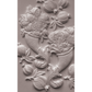 A close-up of a white castng featuring a classic fruit and floral cornucopia motif, including pomegranates, cherries, and bouquets, set against a matching textured background.