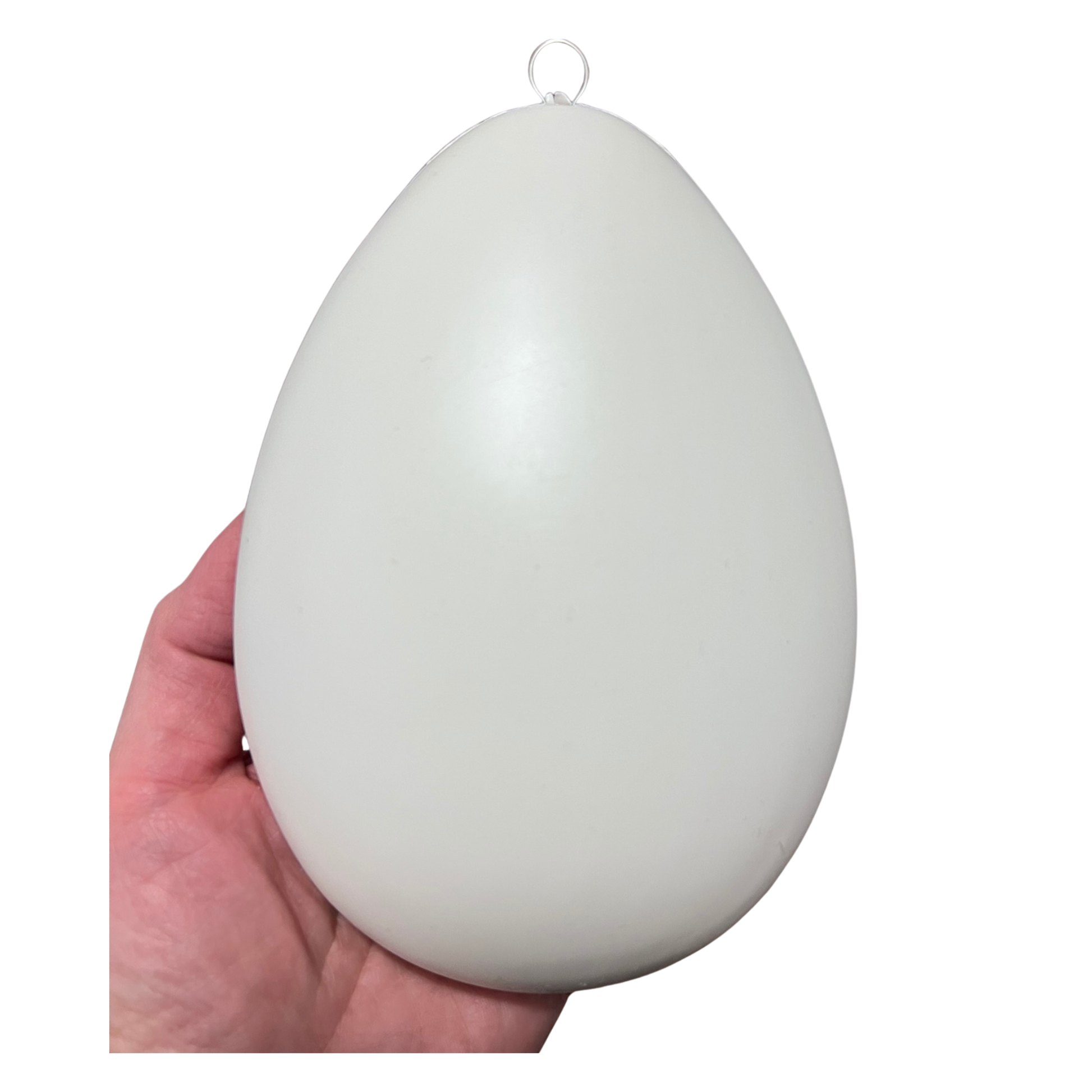 White egg-shaped ornament blank held in a hand against a white background