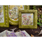 Decorative frames with floral designs on a wooden surface