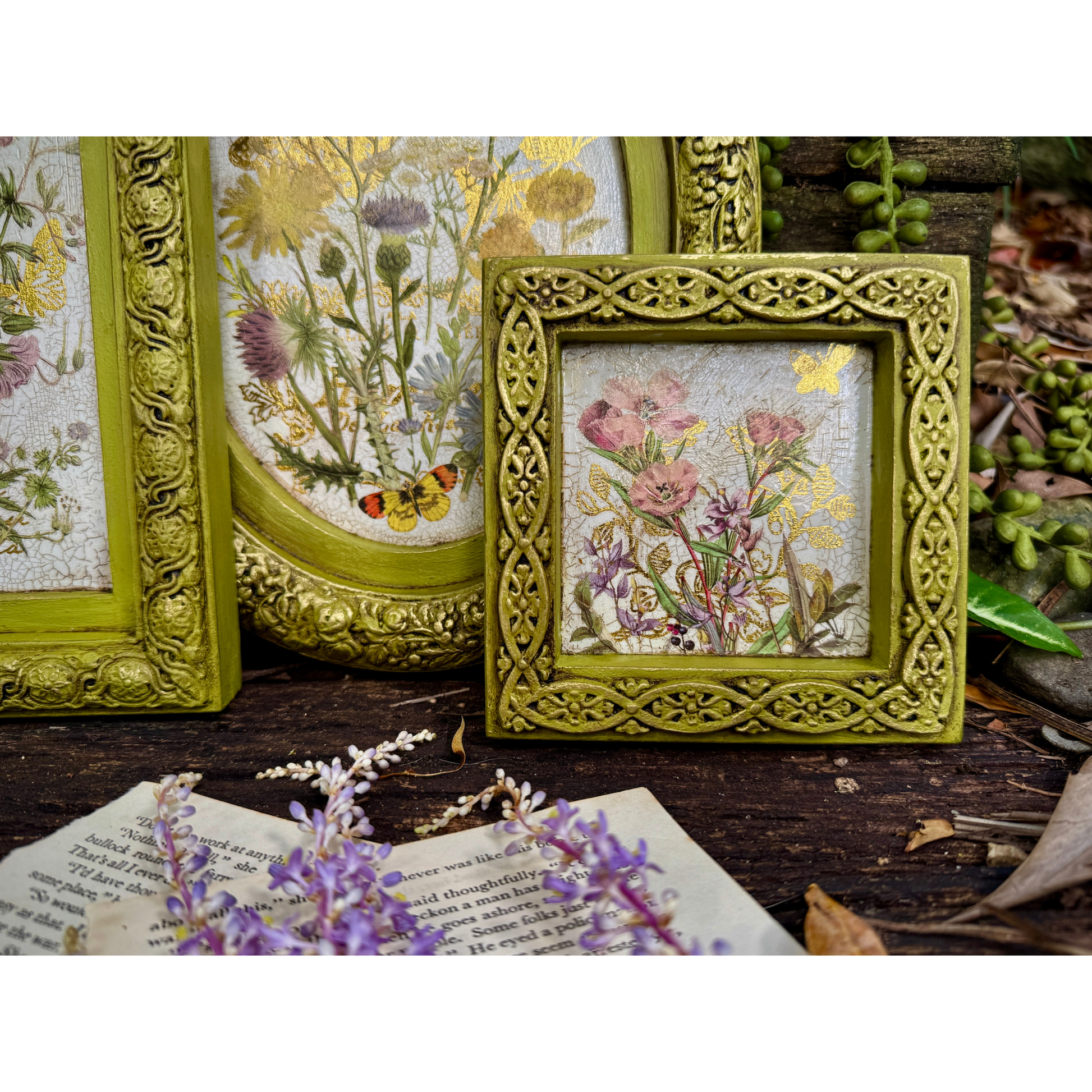 Decorative frames with floral designs on a wooden surface
