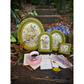 Decorative frames with floral designs on a natural setting with a cup and saucer.