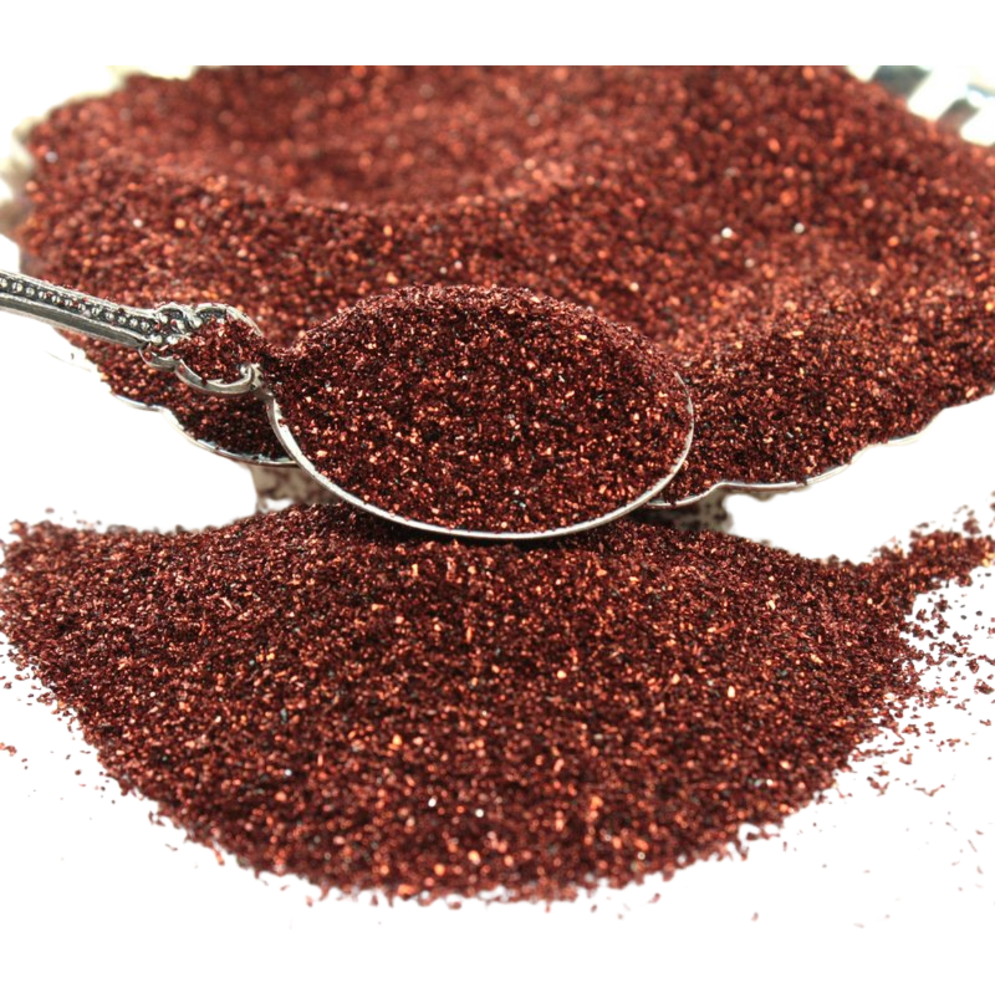 Red glitter with a spoon on a white background