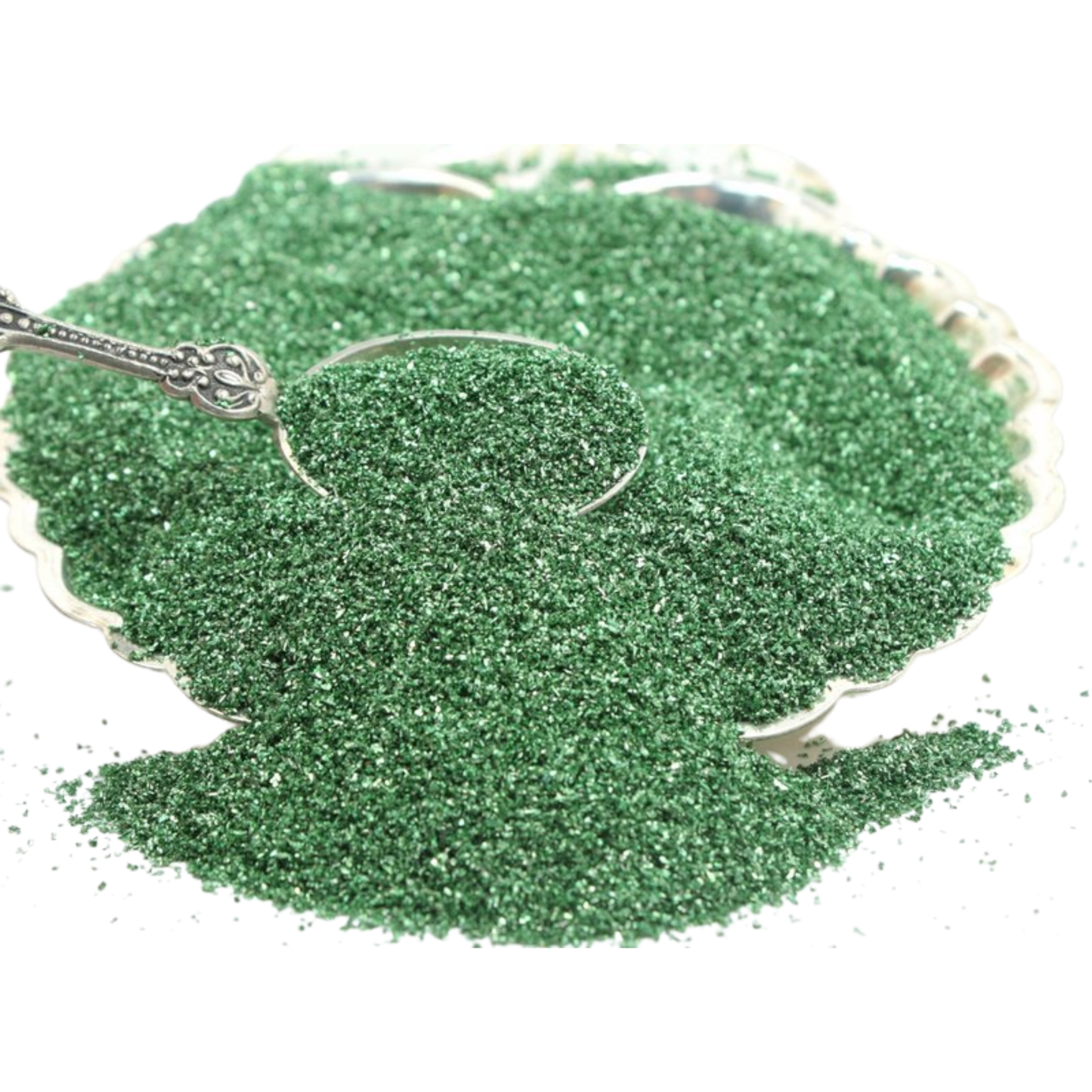 Green glitter in a silver dish with a silver spoon