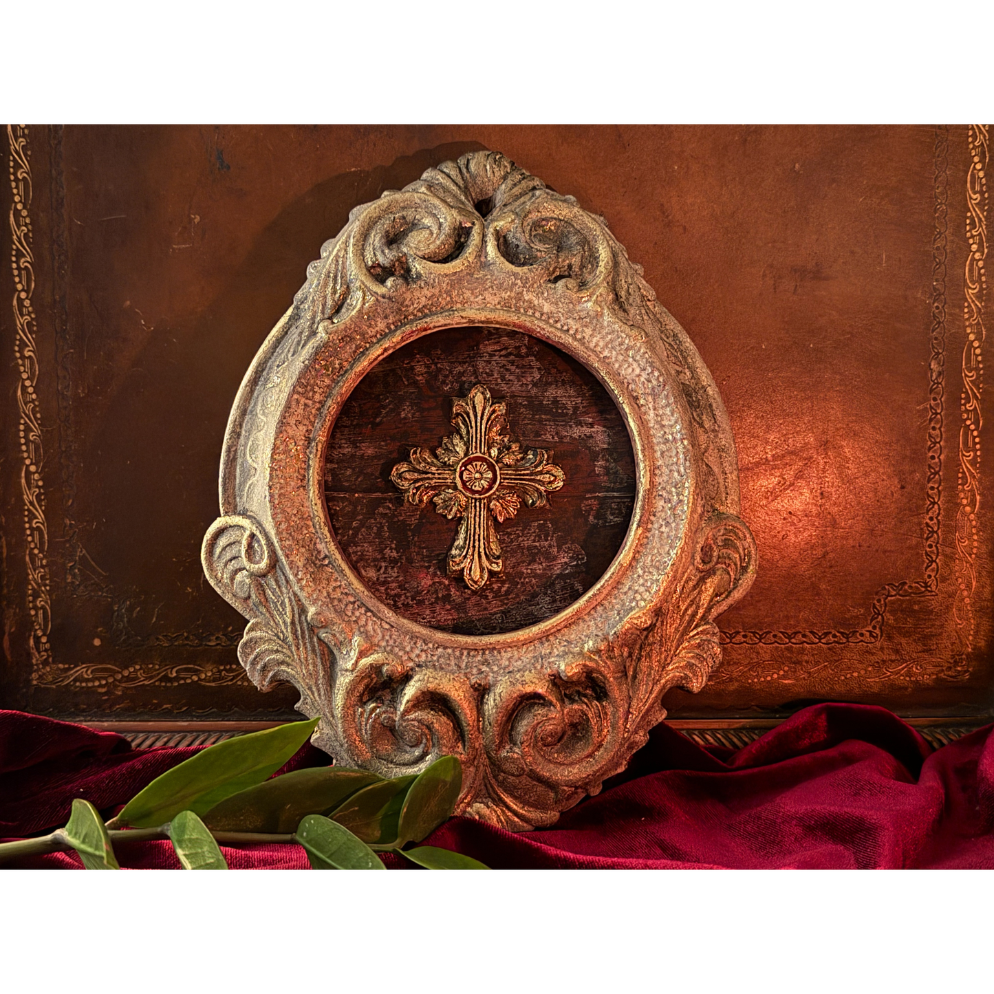 Decorative plate with a cross design in a decorative frame.
