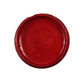 Open jar of red metallic paint on a white background