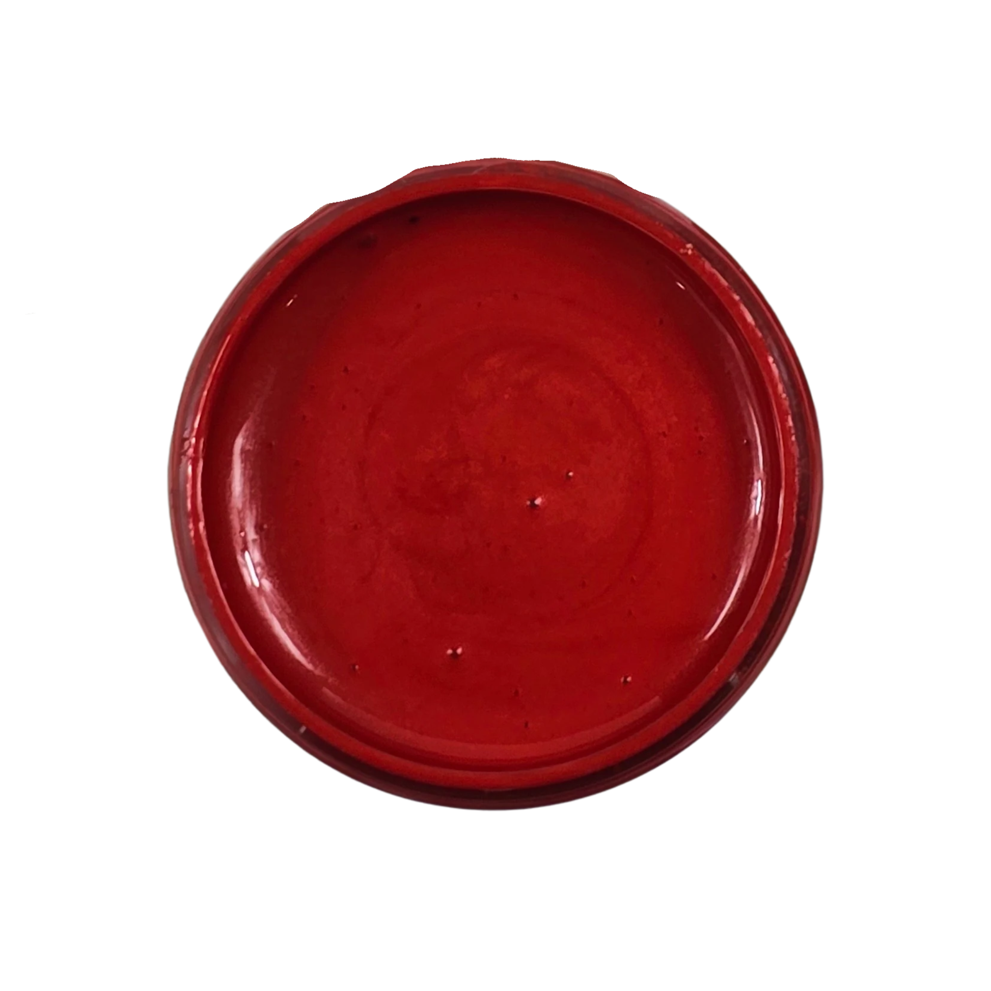Open jar of red metallic paint on a white background