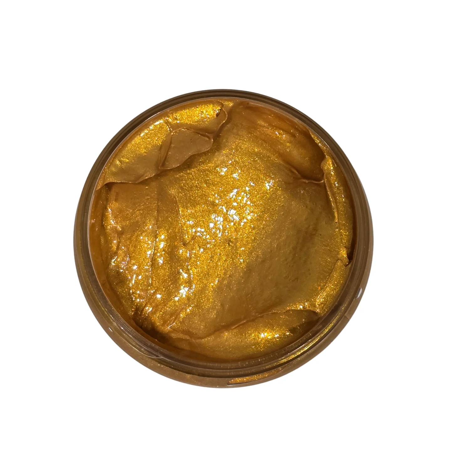 Gold colored paste in a jar on a white background.