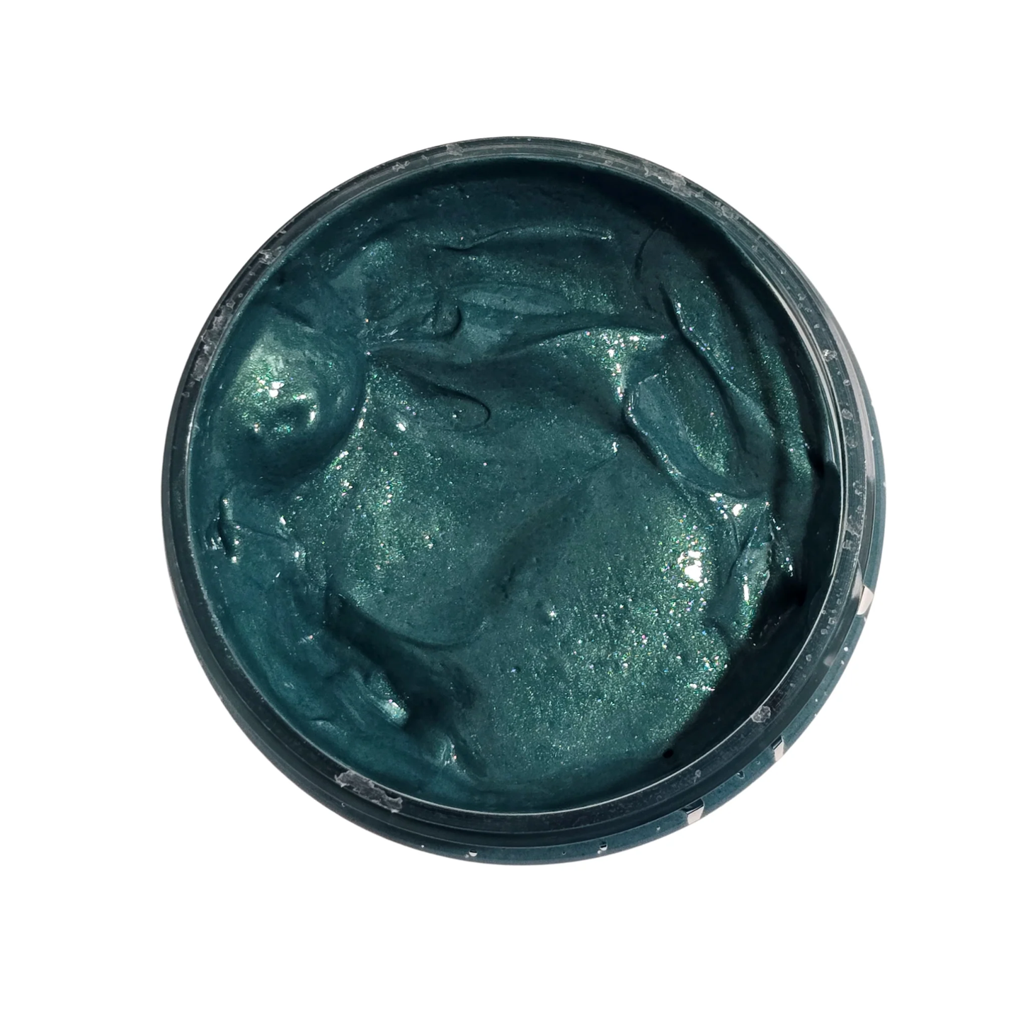 Deep green colored paste in a jar on a white background.
