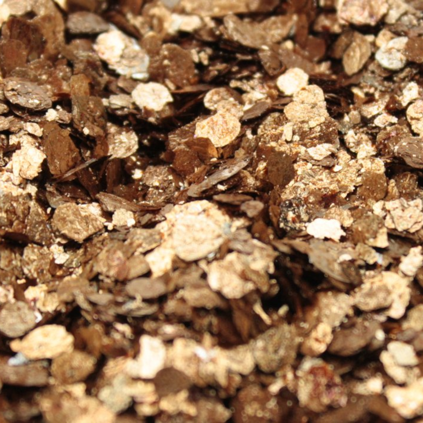 Close-up of a pile of brown and beige mica flakes