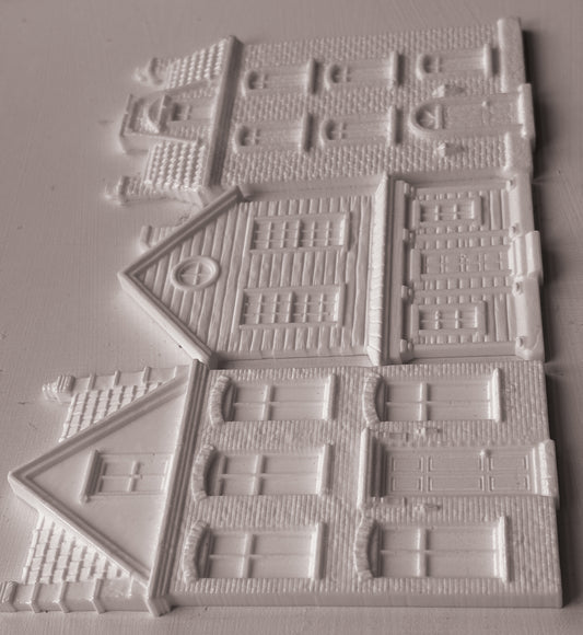 IOD Mould Old Colchester Road castings, featuring  detailed house designs with windows, doors, and textured brick patterns, arranged on a light gray background.