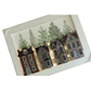 A rectangular decorative wall art piece featuring a row of detailed miniature-style houses in brown, gray, and beige tones, with green trees above and a white border around the artwork.