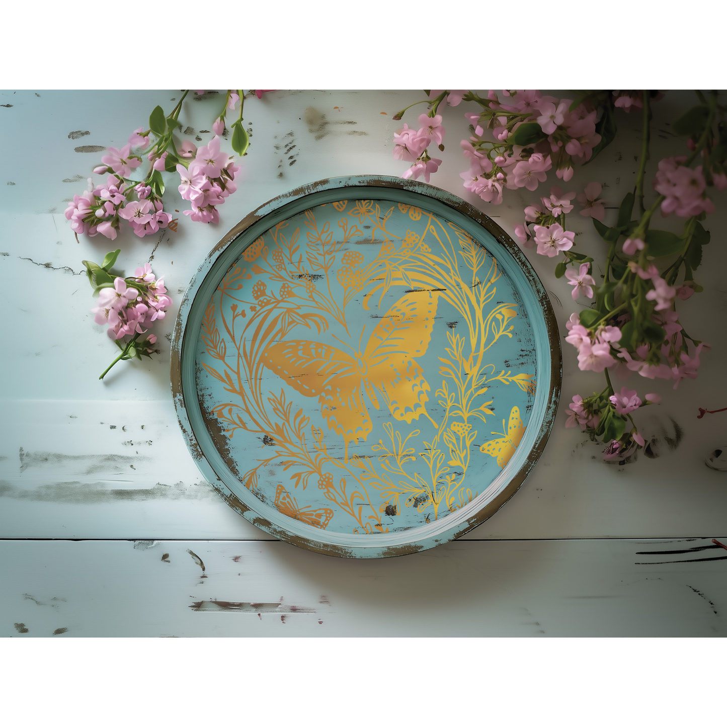 Decorative tray with butterfly design on a blue surface with pink flowers