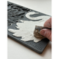 Hand using a tool to add clay into IOD Swans Mould by Iron Orchid Designs.