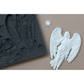 A dark gray silicone mold featuring corresponding casting of an angel with wings and stars, shown next to a white angel figurine and a small white star on a beige background.