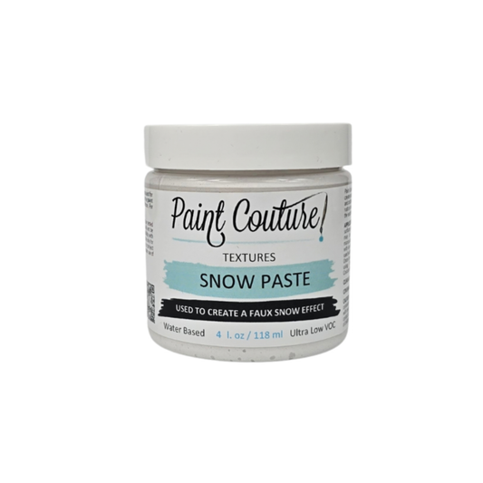 A jar of Paint Couture Textures Snow Paste on a solid white background. The product is a water-based texture paste in a clear jar with a white lid and a white label featuring a light blue accent banner.