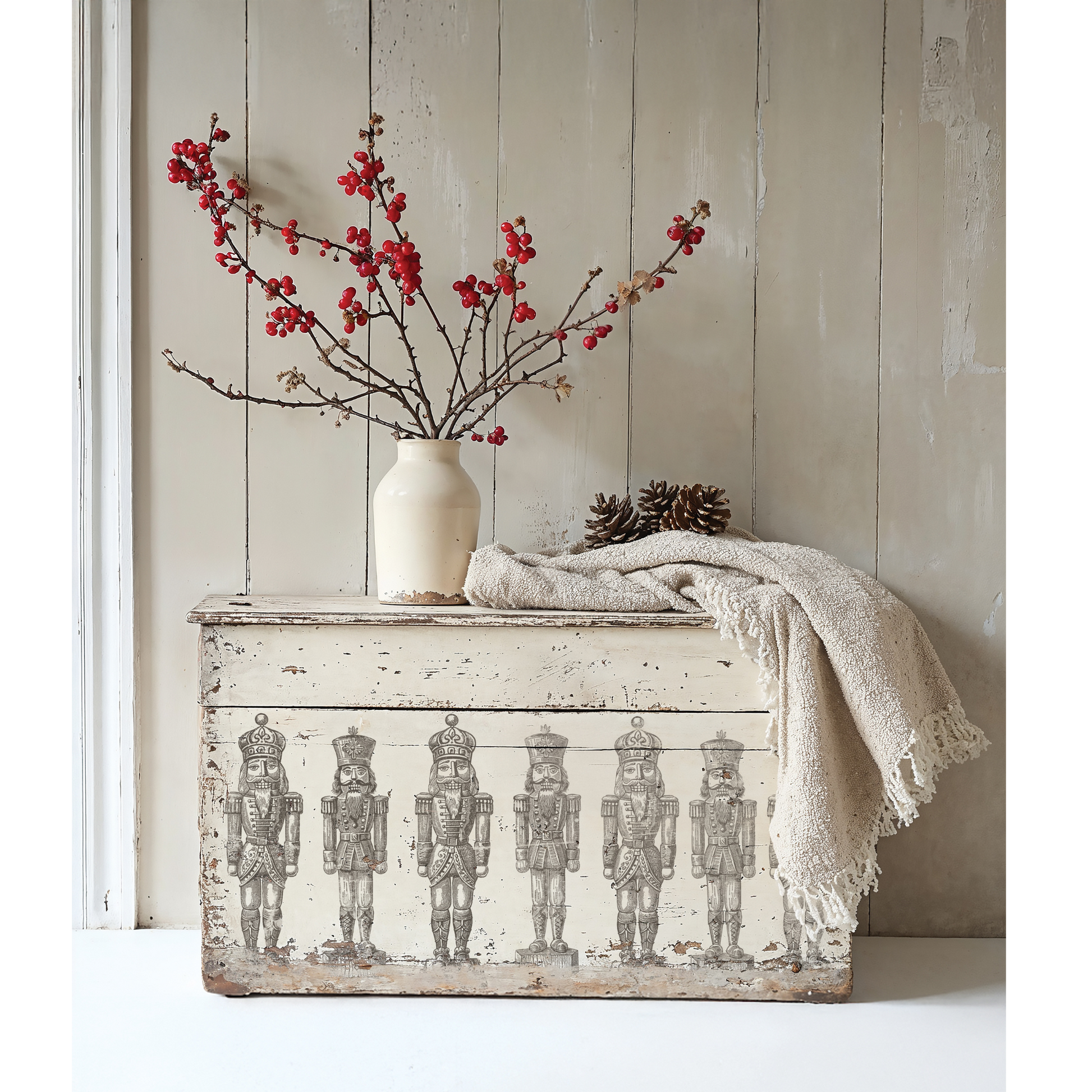 "Sugar Plum" IOD stamp by Iron Orchid Designs. SIngle sheet. Available at Milton's Daughter. Example pic. Decorative chest with nutcracker design, white vase with red branches, and blanket against a wooden wall.