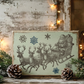 A rectangular vintage-style Christmas sign featuring Santa Claus in a sleigh with reindeer and snowflakes, styled on a rustic wooden surface with pine branches, pinecones, and warm string lights.