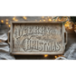 "Twelfth Night" IOD Paint Inlay by Iron Orchid Designs. Example pic 1. Transfer available at Milton's Daughter. Wooden tray with 'Merry Christmas' text on a wooden surface with string lights and a tree.