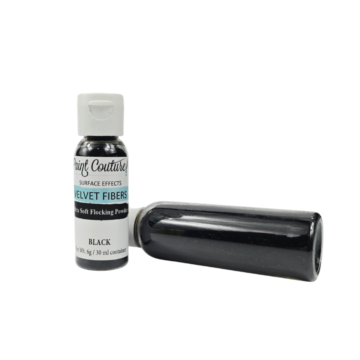 A small bottle of black velvet fibers powder with a white cap, shown upright next to a bottle lying on its side, against a plain white background.