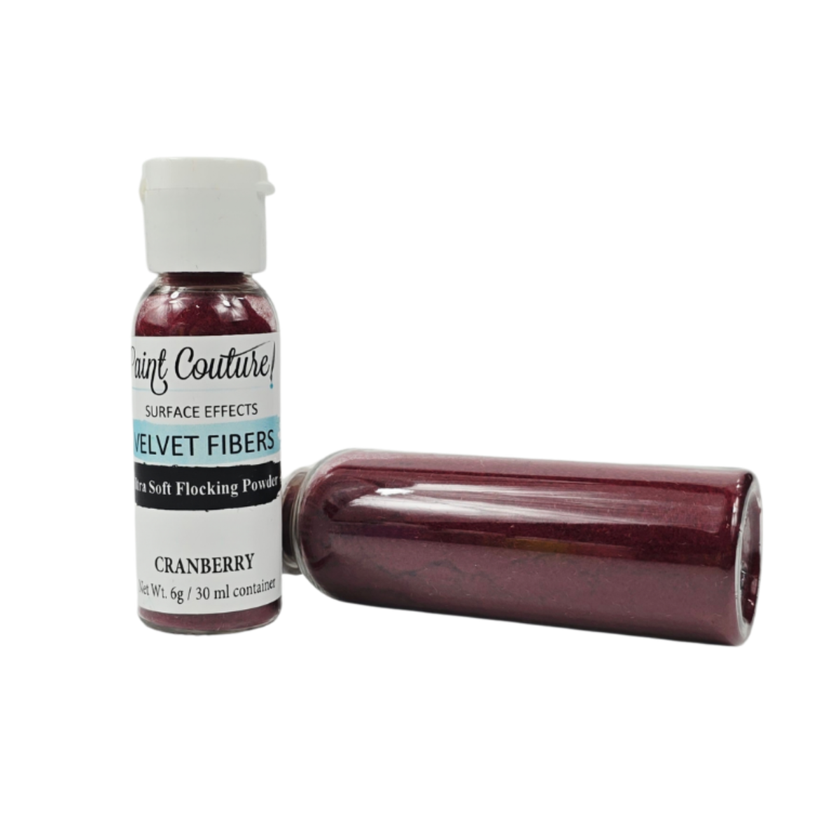 A bottle of  Paint Couture Velvet Fibers soft flocking powder in Cranberry, shown upright next to a horizontal bottle of the same product on a white background.