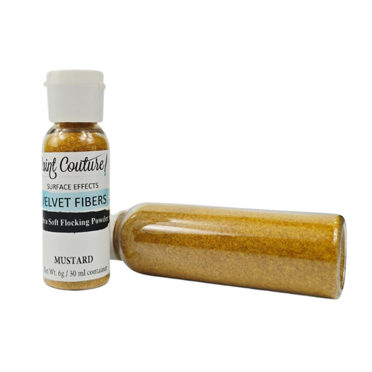 A bottle of Paint Couture Velvet Fibers in the 'Mustard' color, shown alongside a horizontal tube of the velvet powder on a white background.