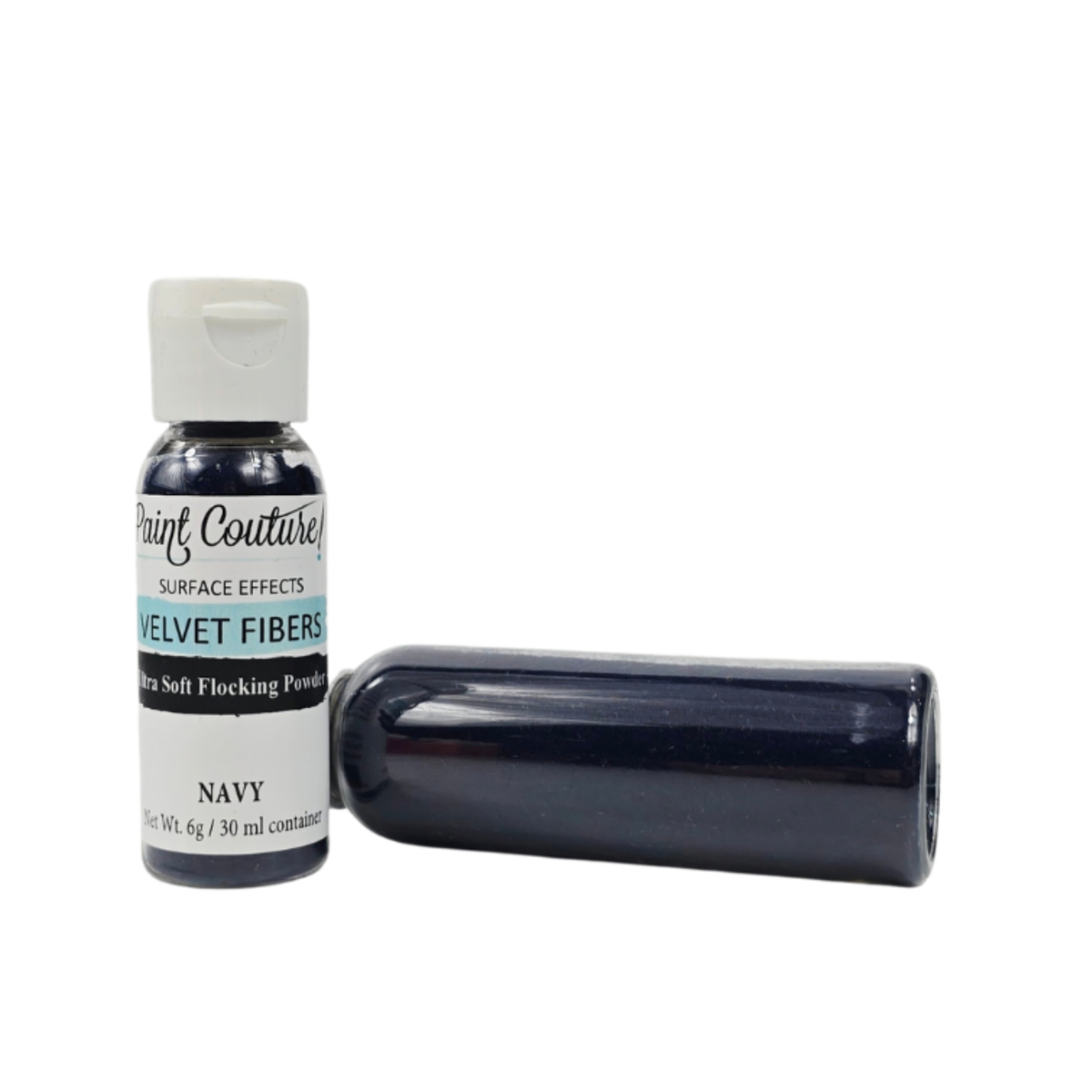 A bottle of Paint Couture Velvet Fibers surface effect powder in Navy, shown next to a bottle lying horizontally