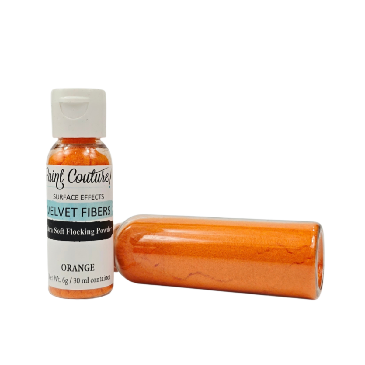 A bottle of Paint Couture Orange Velvet Fibers surface effect powder next to a clear plastic tube filled with the orange powder, on a white background.