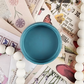 Image of open jar of blue paint.