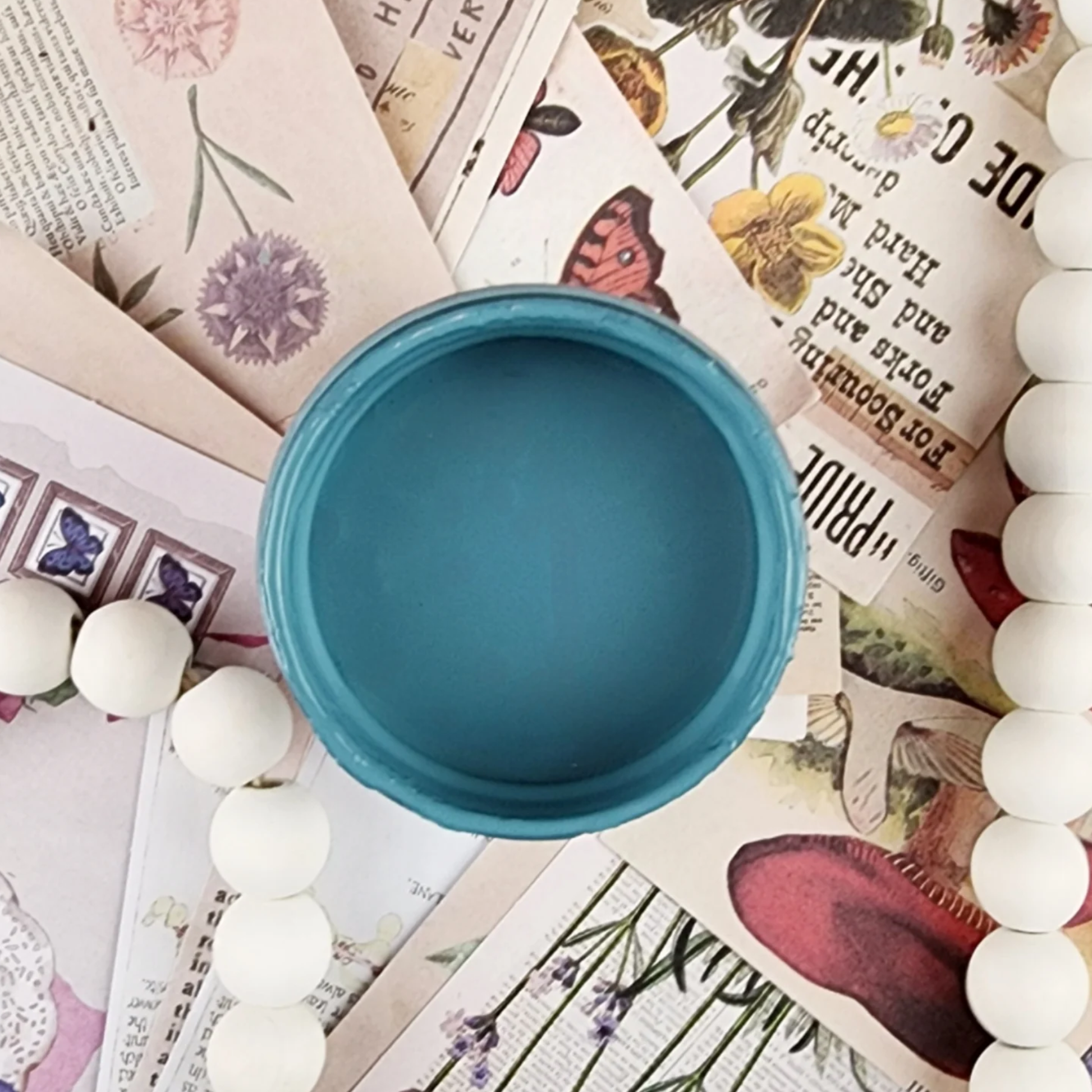Image of open jar of blue paint.