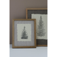 Two framed botanical art prints of pine trees, styled on a white surface against a taupe wall. The front print features a striped linen background with a central cream paper insert showing a black ink stamped image, enclosed in a light oak frame.