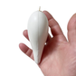 White heart shaped ornament, side view, held in a hand against a white background