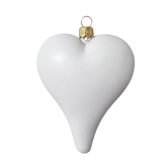 White heart-shaped ornament with a gold accent on a white background