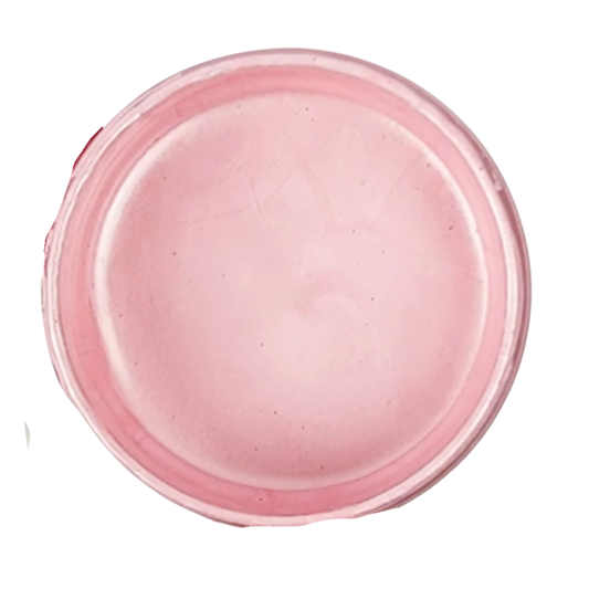 Open jar of pink metallic paint on a white background