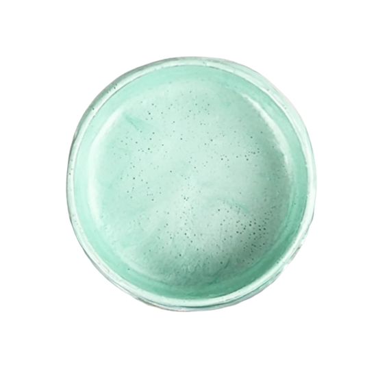 Pale blue-green metallic paint on a white background