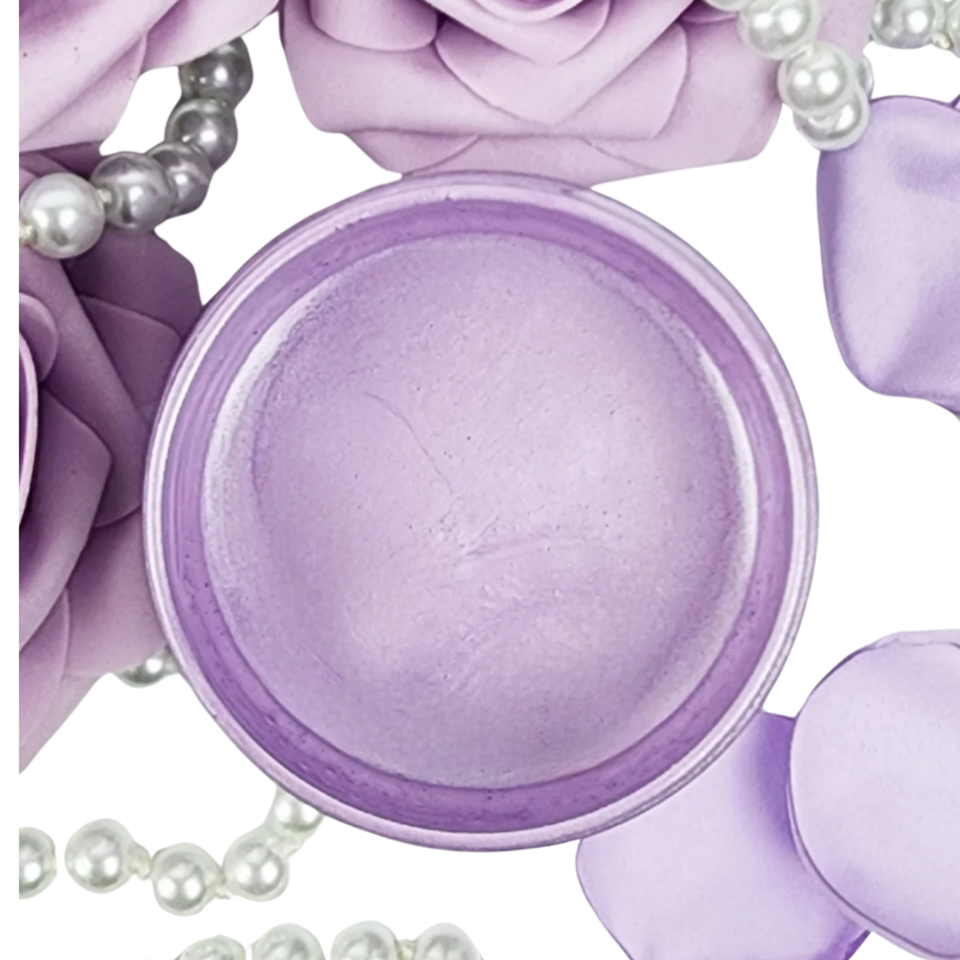 Open jar of light purple metallic paint with pearls and rose petals.