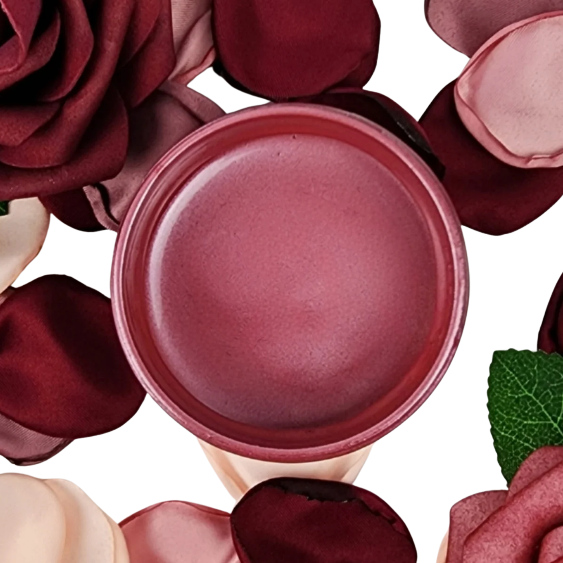 Open paint jar with deep pink metallic paint surrounded by red and pink roses on a white background