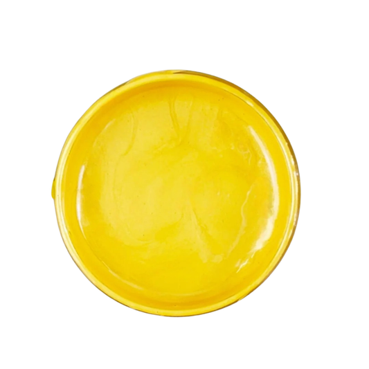 Open jar of bright yellow metallic paint on a white background.