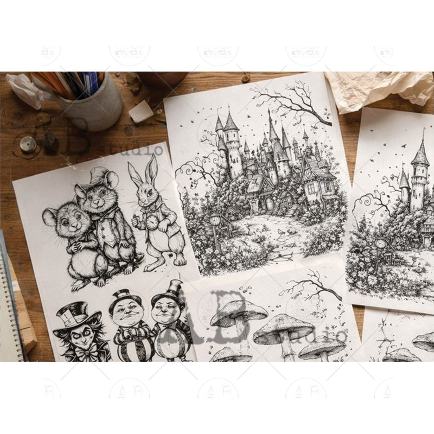 Collection of black and white drawings on a wooden surface