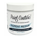 A white plastic jar of Paint Couture Pigment Medium with a white label and black text, shown on a plain white background.