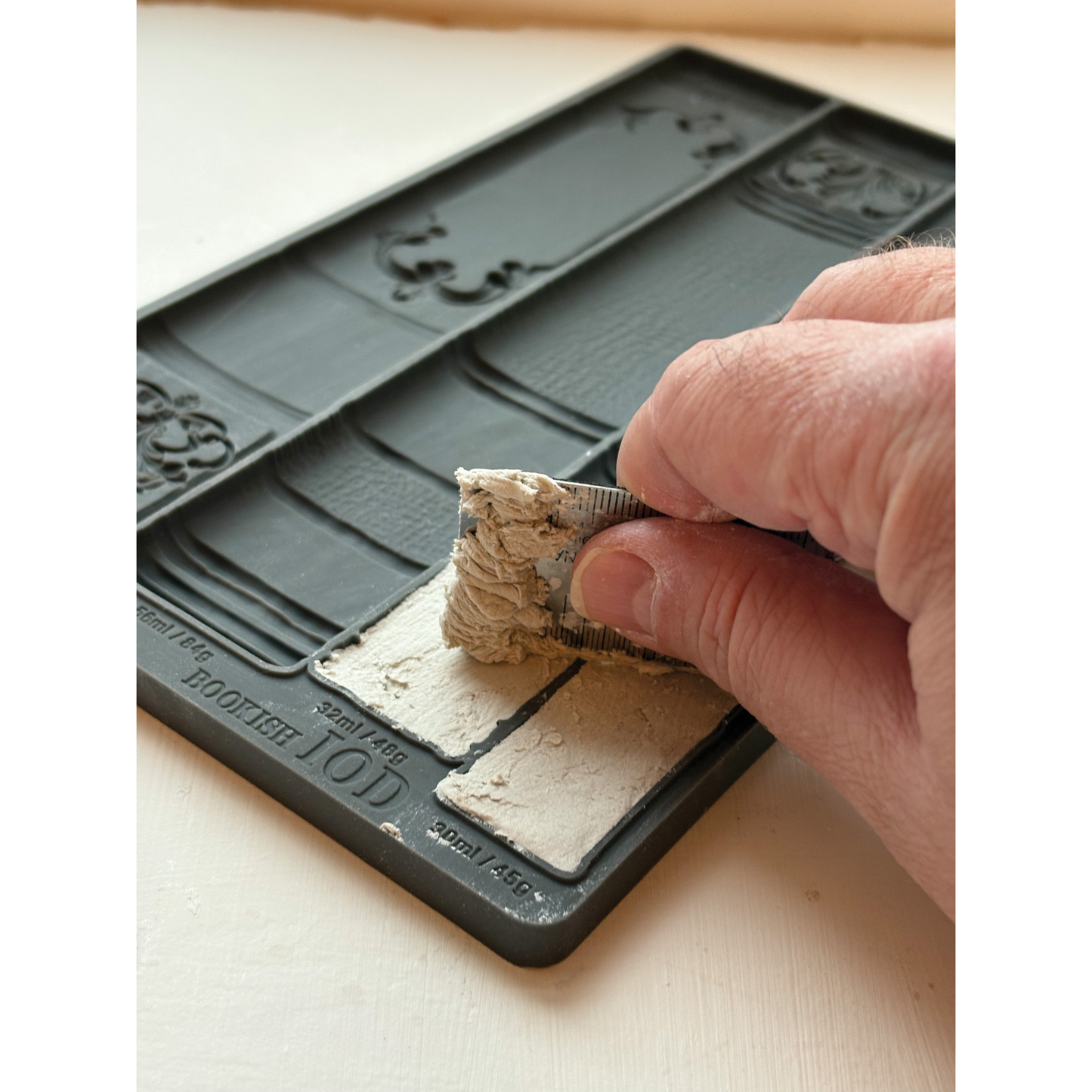 Example of IOD Bookish Mould being filled with clay.